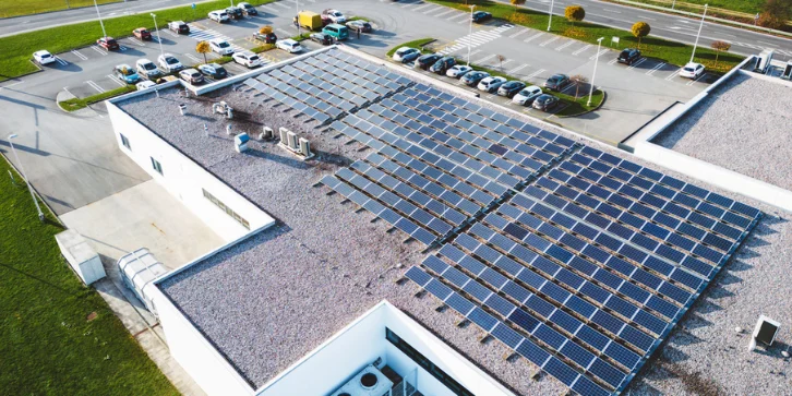 Solar Panels for Office Buildings. An image of a large-scale solar panel installation on roof of office building.