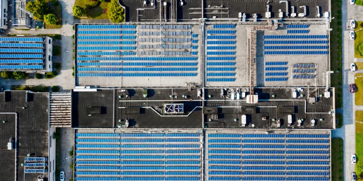 Solar Panels for Manufacturing Plants. An image of an aerial view of solar panels installed on factory rooftop.
