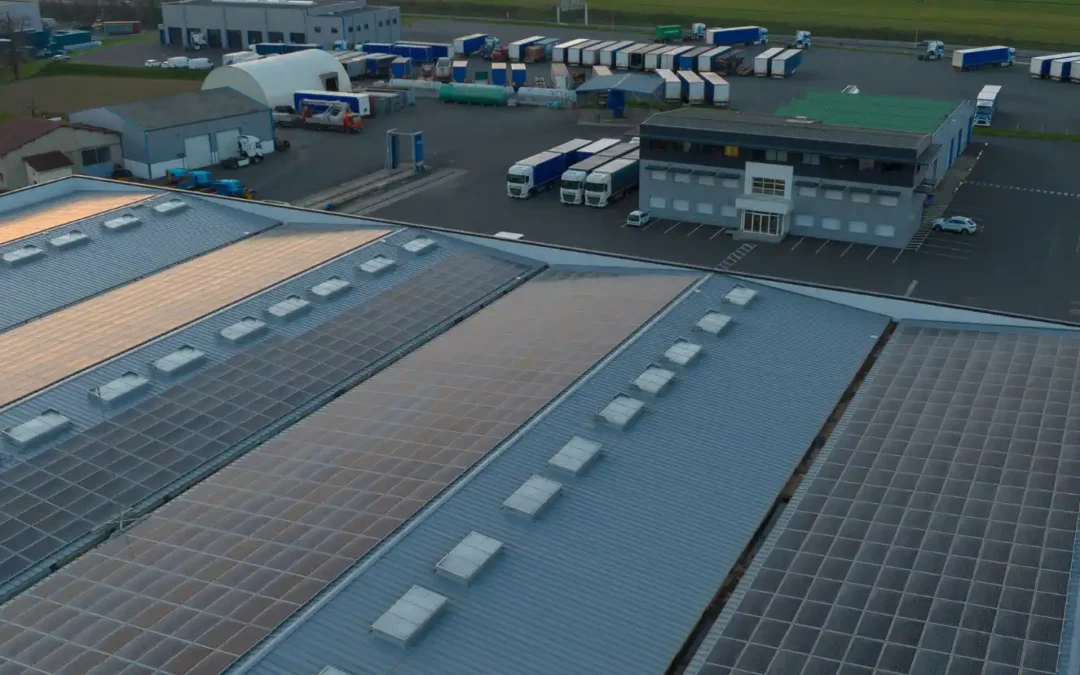 Solar Panels for Warehouse. An image of an aerial view of a warehouse containing solar panels on the roof of the building for producing green ecological electricity