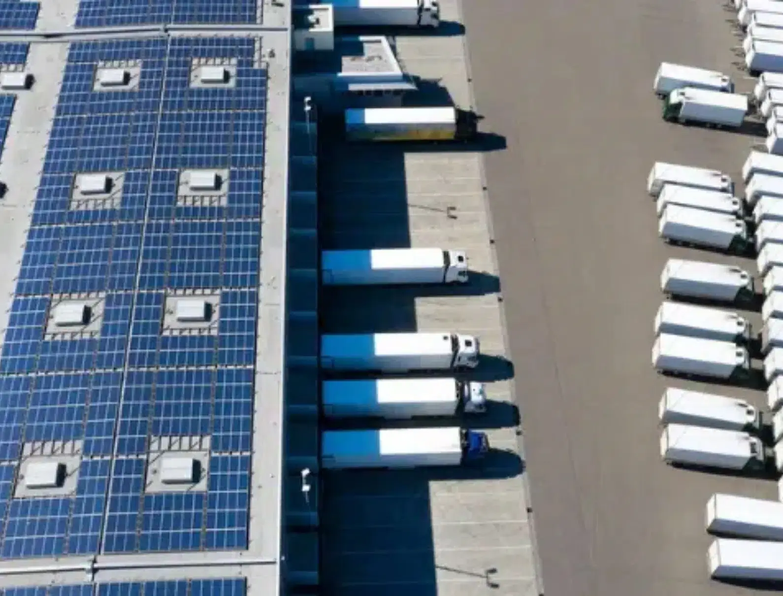 Solar energy panels on warehouse building rooftop